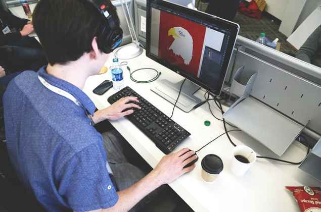 Job Oriented Course in Graphic Designing A man learning Graphic Designing on Computer